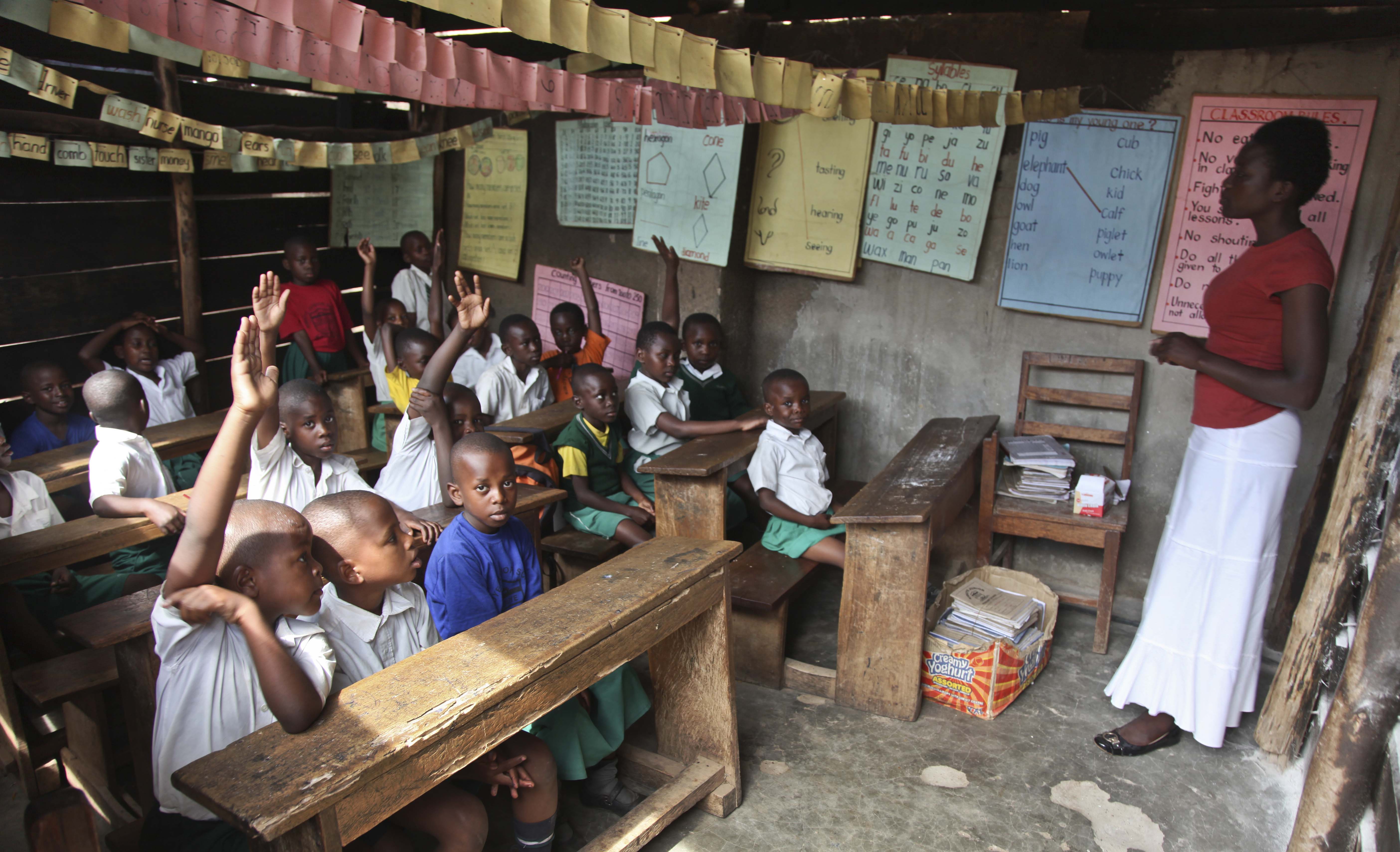Pupils sit in a classroom at the Kibuye Junior Primary School in the Katwe slum of Kampala, Uganda, October 14, 2016.