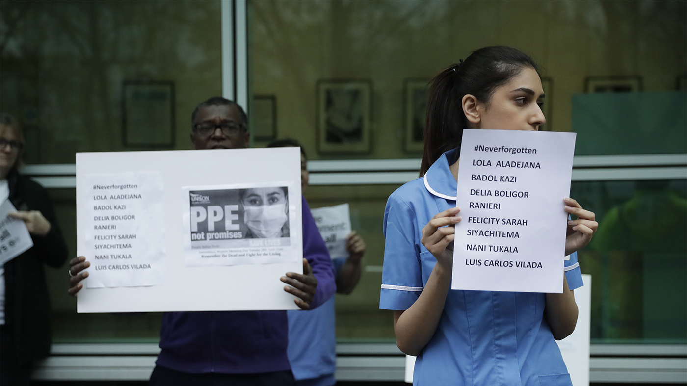 Hospital workers remember their colleagues who have died from coronavirus and call on UK health authorities to provide personal protective equipment at University College Hospital in London, April 2020.
