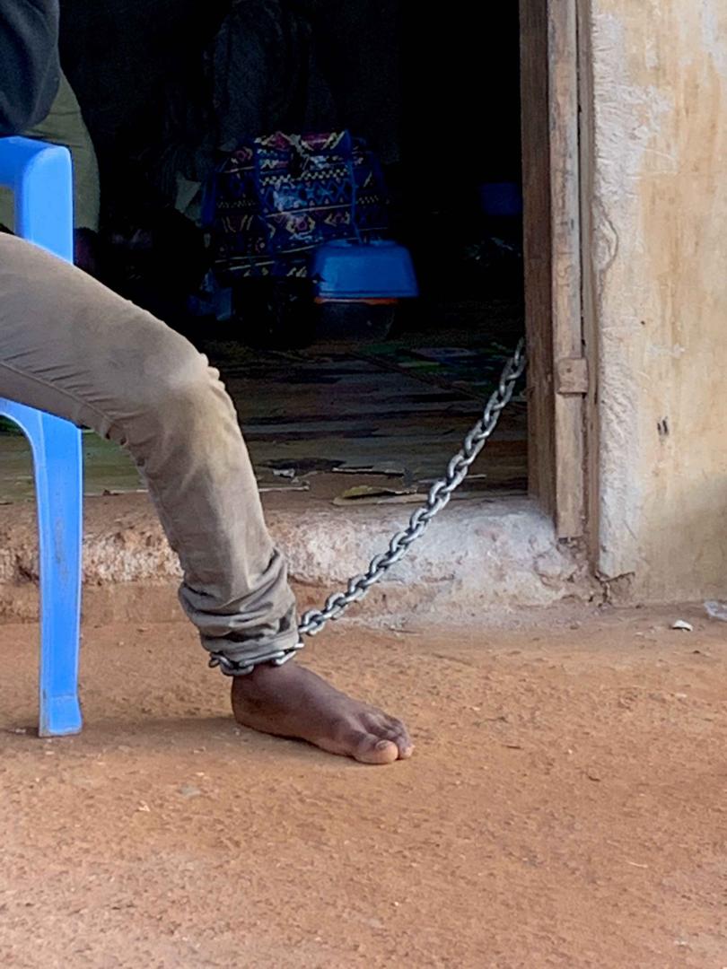 A man with a real or perceived mental health condition held in a chain around his ankle at a traditional healing center in the Greater Accra Region in Ghana. 