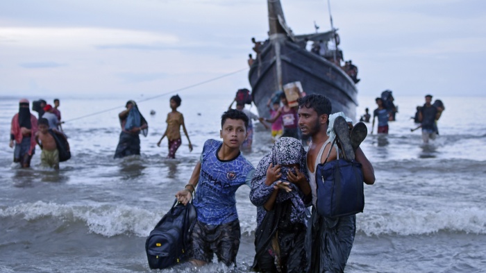 Rohingya asylum seekers disembark from their boat upon landing in Ulee Madon, North Aceh, Indonesia, November 16, 2023.