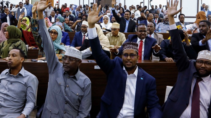 Somali members of Parliament vote on a resolution on the procedural rules for constitutional amendments, Mogadishu, Somalia, January 24, 2024.