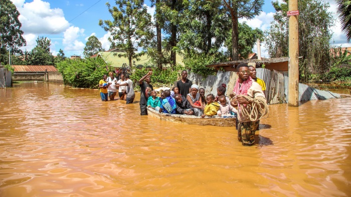 A family uses a boat after fleeing floodwaters that wreaked havoc in the Githurai area of Nairobi, Kenya, April 24, 2024.