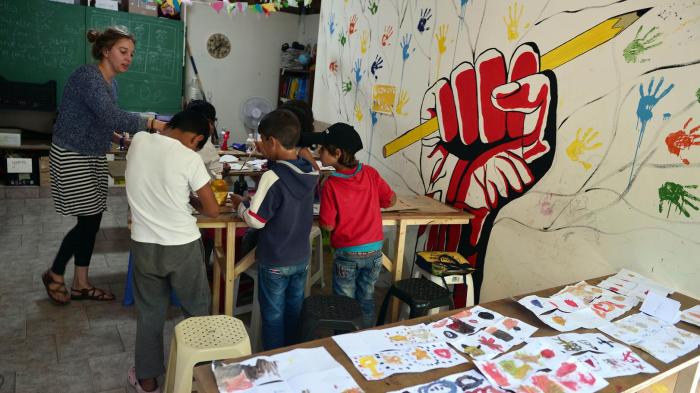 Children seeking asylum attend an art class at the volunteer-run Refugee Education Chios center on the Greek island of Chios on September 29, 2016. 