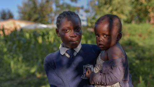 “Evelina,” 17, with her 3-year-old daughter “Hope,” in Migori county, western Kenya. Evelina is in Form 2, the second year of lower secondary school.