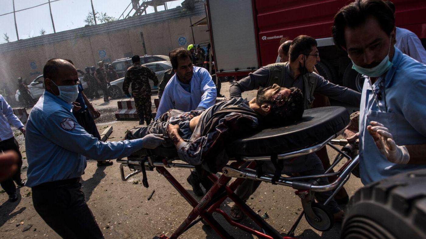 Medical workers transport an injured man on a stretcher to an ambulance near the site of a truck bomb in Kabul, May 31, 2017. 