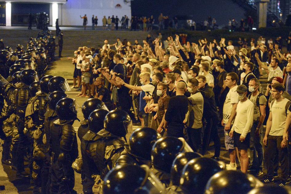 People argue with police during a rally after the Belarusian presidential election in Minsk, Belarus, late Sunday, Aug. 9, 2020.