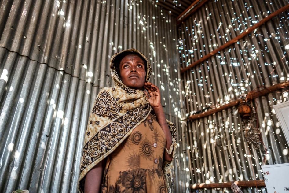 A woman stands in a metal sheet room that was damaged by shelling in Humera town, Tigray region, Ethiopia, on November 22, 2020. In that residential compound, two women and an elderly man were killed by shelling and gunfire, and two women were wounded.