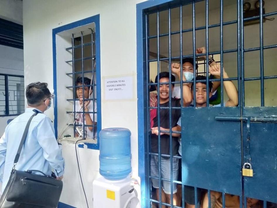 Arrested teachers and adult Indigenous students confer with their lawyer while detained in a Cebu City jail. 