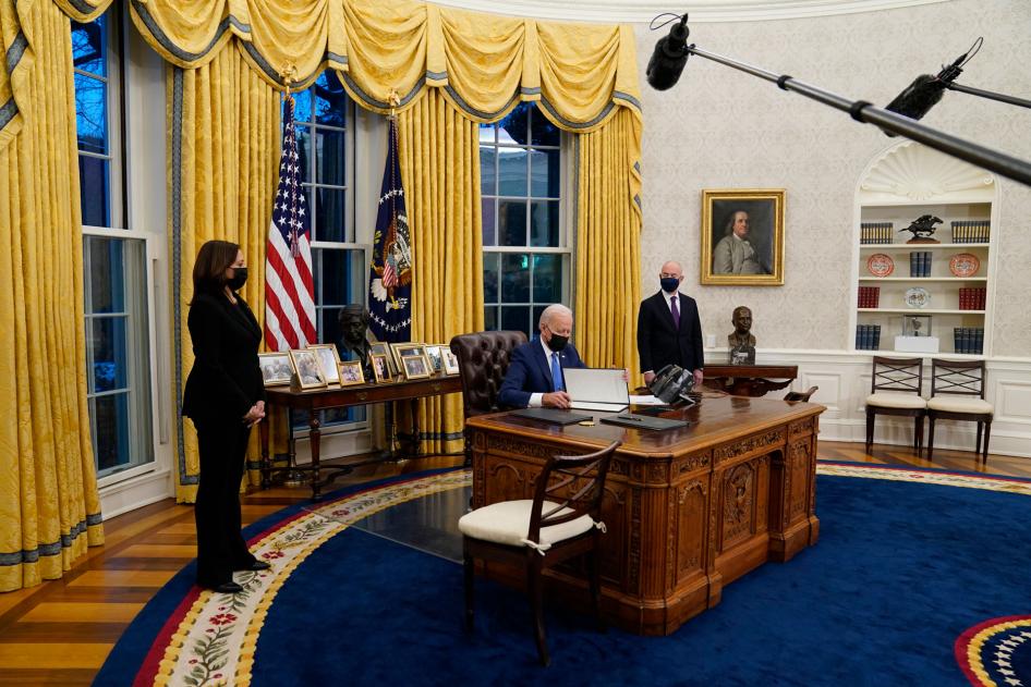Vice President Kamala Harris, left, and Secretary of Homeland Security Alejandro Mayorkas, right, watch as President Joe Biden signs an executive order on immigration in the Oval Office of the White House in Washington, February 2, 2021.