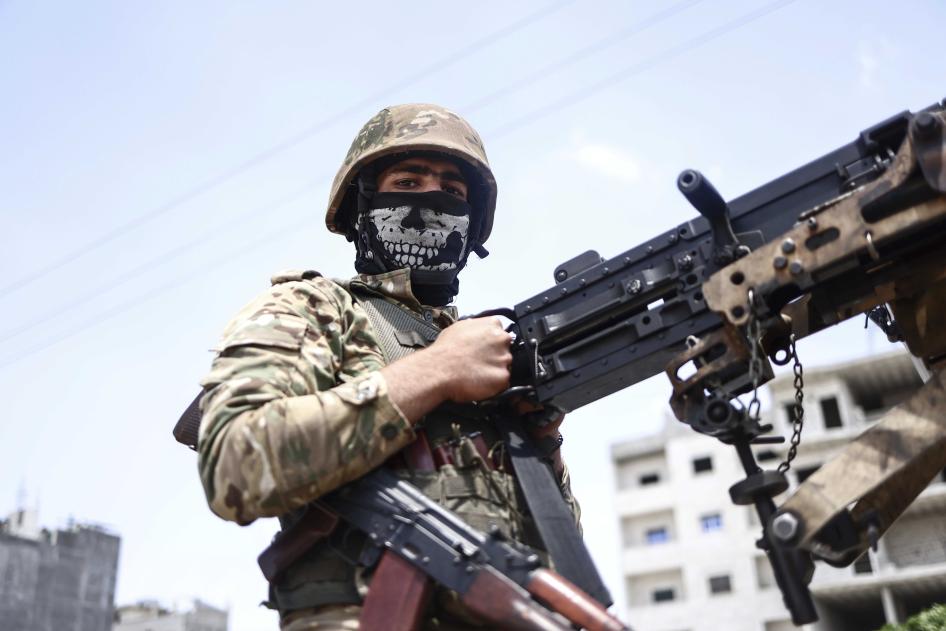 Türkiye destekli Suriye Milli Ordusu'nun bir savaşçısı, Suriye Demokratik Güçleri tarafından kontrol edilen bölgelere yönelik askeri harekat için hazırlıklar kapsamında 9 Haziran 2022'de Halep Valiliği kırsalında düzenlenen askeri bir geçit törenine katılıyor. 