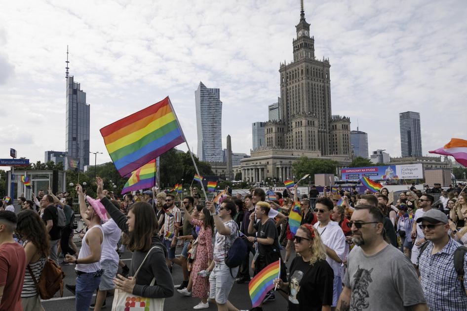 People march through the street with rainbow flags during the Warsaw's Equality Parade, Poland, June 17, 2023. 