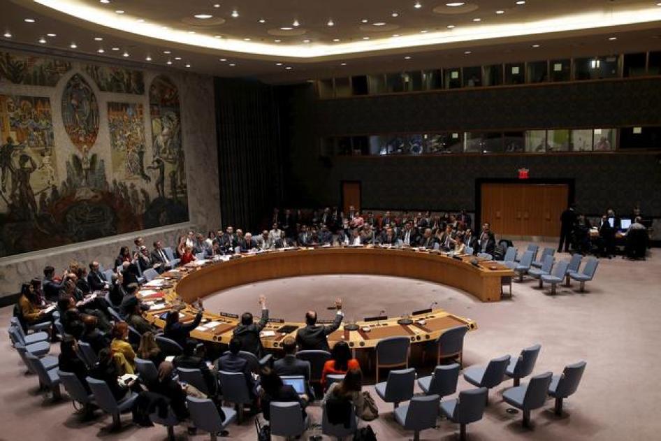 Security Council members cast their votes in favor of the adoption of the agenda on human rights abuses by North Korea in New York on December 10, 2015.