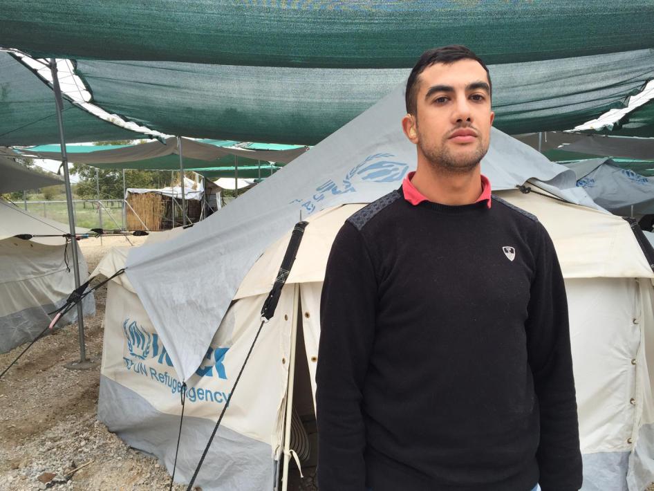 Amin, 24, a Syrian deaf man in front of his tent in Lagkadikia camp, Thessaloniki. Amin rarely left this tent for months because he did not have his hearing aids, which were damaged on his journey to Greece. Photograph by Emina Cerimovic. ©October 2016 Hu