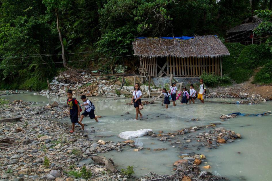 School children cross a mercury-polluted river in Malaya, Camarines Norte, Philippines.