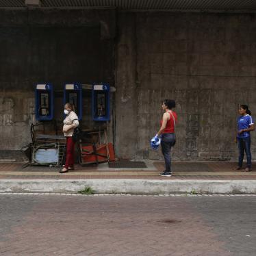 Women practice social distancing as they wait in line to enter a supermarket, on a day that men must stay indoors in Panama City on April 3, 2020.