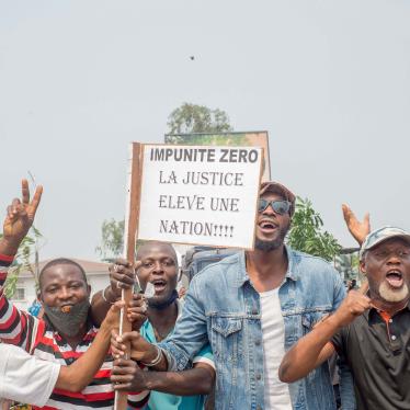 Protesters, including many motorbike-taxi drivers, demonstrate while holding placards for the second day around the Parliament in Kinshasa, June 24, 2020.