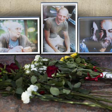 Flowers are placed by portraits of slain journalists Alexander Rastorguyev, Kirill Radchenko, and Orkhan Dzhemal, at the Russian Journalists’ Union building in Moscow on August 1, 2018.