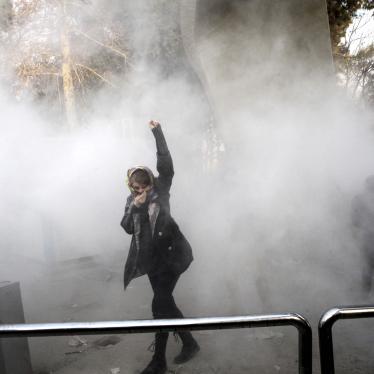 On December 30, 2017, a university student attends a protest inside Tehran University while a smoke grenade is thrown by anti-riot Iranian police, in Tehran, Iran.