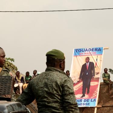 Presidential guards stand guard in Bangui, on December 12, 2020, during the opening campaign rally for incumbent president Faustin-Archange Touadéra, seen in the poster, a candidate in the December 2020 elections.