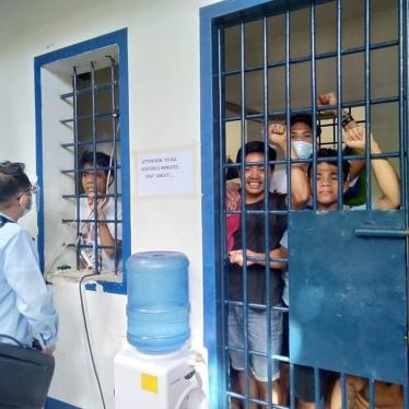 Arrested teachers and adult Indigenous students confer with their lawyer while detained in a Cebu City jail. 