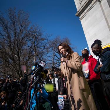 Lindsey Boylan, a former state economic development adviser for New York Governor Andrew Cuomo, speaks in front of microphones and a crowd of people holding signs at a rally in New York City, March 20, 2021. 