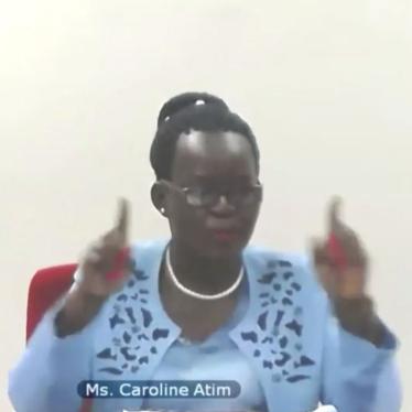 Caroline Atim, wearing a blue dress, addresses the United Nations Security Council during a virtual meeting, April 14, 2021. She is seated in front of a black background.