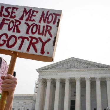 A person holds a protest sign that says "Use Me Not For Your Bigotry"