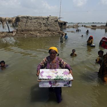 Women carry belongings salvaged from their flooded homes after monsoon rains in the Qambar Shahdadkot district of Sindh province, Pakistan, September 6, 2022.