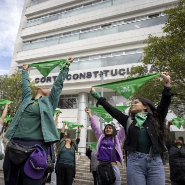 Women from different organizations that are part of the Justa Libertad movement raise green scarves outside the Constitutional Court of Ecuador in Quito, March 19, 2024.