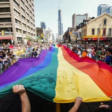 Revellers hold a giant pride flag during the "WorldPride" gay pride Parade in Toronto, June 29, 2014.