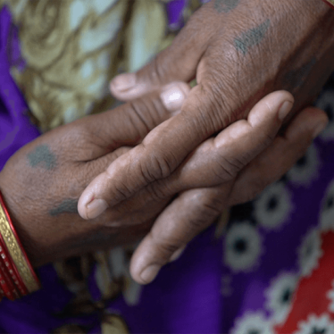 A close-up photo showing the hands of a sexual violence victim in India.