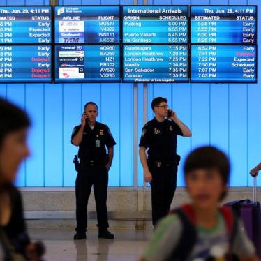 U.S. Customs and Immigration officers keep watch at the arrivals level at Los Angeles International Airport in Los Angeles, California, U.S., June 29, 2017.