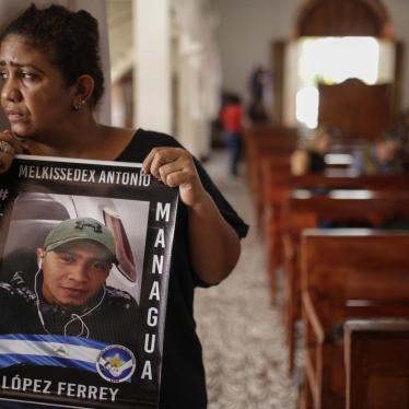 Martha Lorena Alvarado, mother of jailed anti-government demonstrator Melkissedex Antonio Lopez, holds a sign with an image of her son while participating in the hunger strike at the San Miguel Arcangel Church in Masaya, Nicaragua, on Thursday, November 1