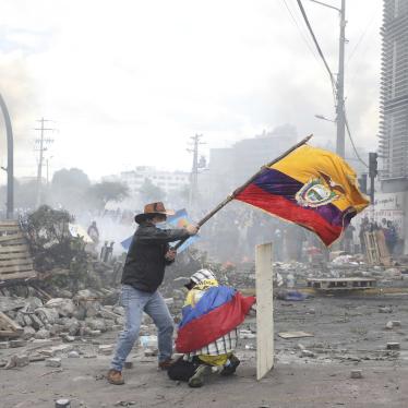 An anti-government demonstrator on Oct. 12, 2019 in Quito, Ecuador, waves the national flag during sometimes violent protests which began when President Lenin Moreno's decision to cut subsidies led to a sharp increase in fuel prices. 