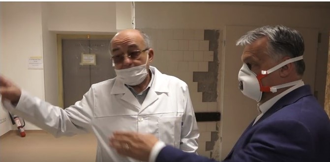 Prime Minister Orban in early April visiting the Budapest Korányi Institute of Pulmonology  - a clinic with specific responsibility for Covid-19 patients. In the background are some indications of disrepair including tiles falling off the wall and an “out of order” sign on the elevator.