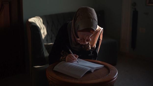 אימאן אבו ג'ראד, אישה בת 21 עם ליקוי ראייה, מנסה ללמוד במהלך הפסקת חשמל ברצועת עזה. "כשהחשמל מנותק בשעות הערב ואז חוזר, לוקח שעה עד שהראייה שלי מתאוששת", אמרה אבו ג'ראד לארגון Human Rights Watch.