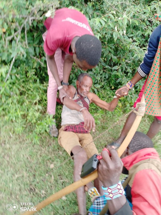 Tanzanian Maasai people helping an older Maasai man who had been beaten and injured by Tanzanian security forces after the outbreak of violence on June 10, 2022, in Loliondo, Arusha region, Tanzania. 