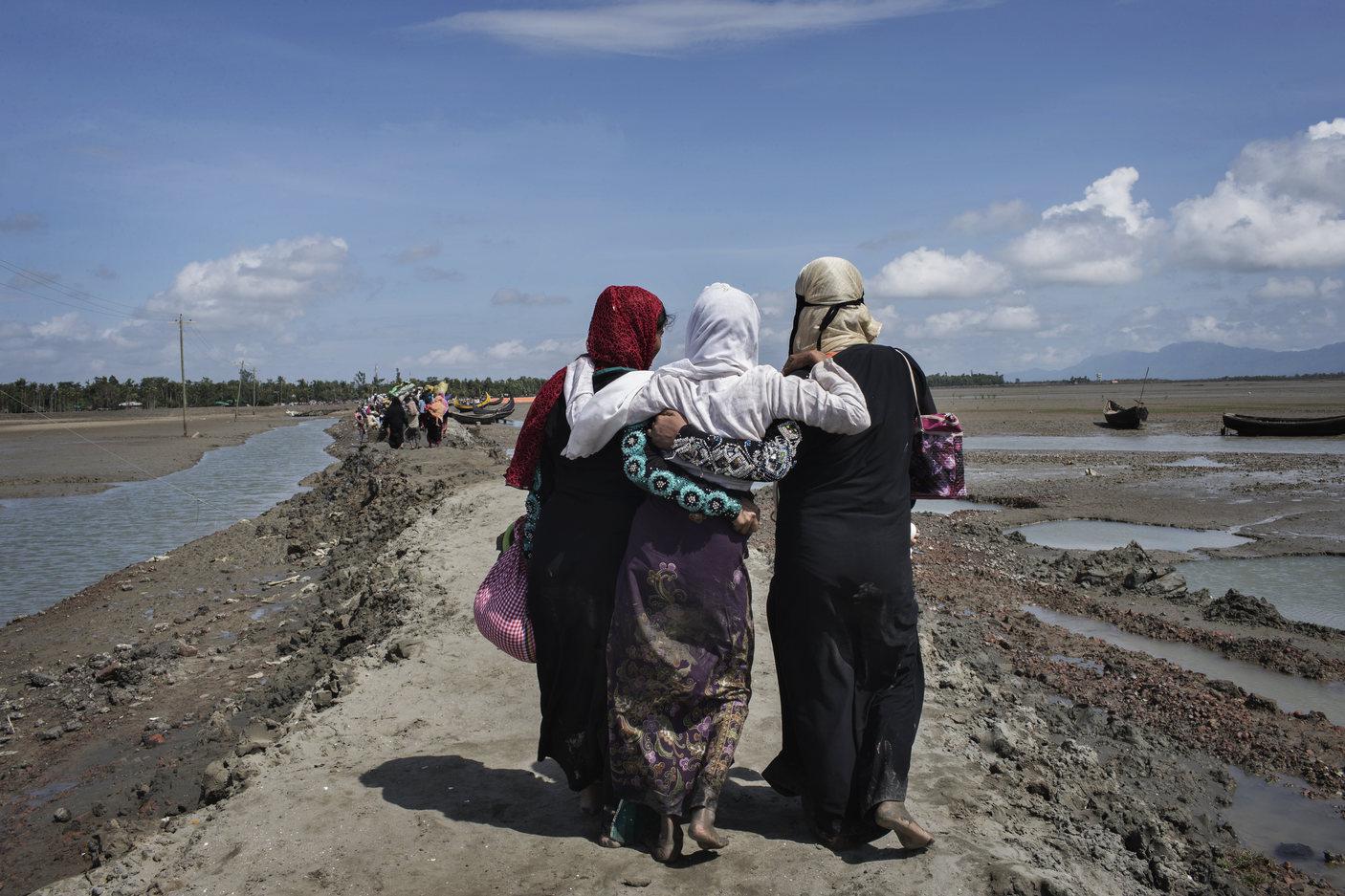 Rohingya women refugees who crossed the Naf River from Burma into Bangladesh continue inland toward refugee camps.