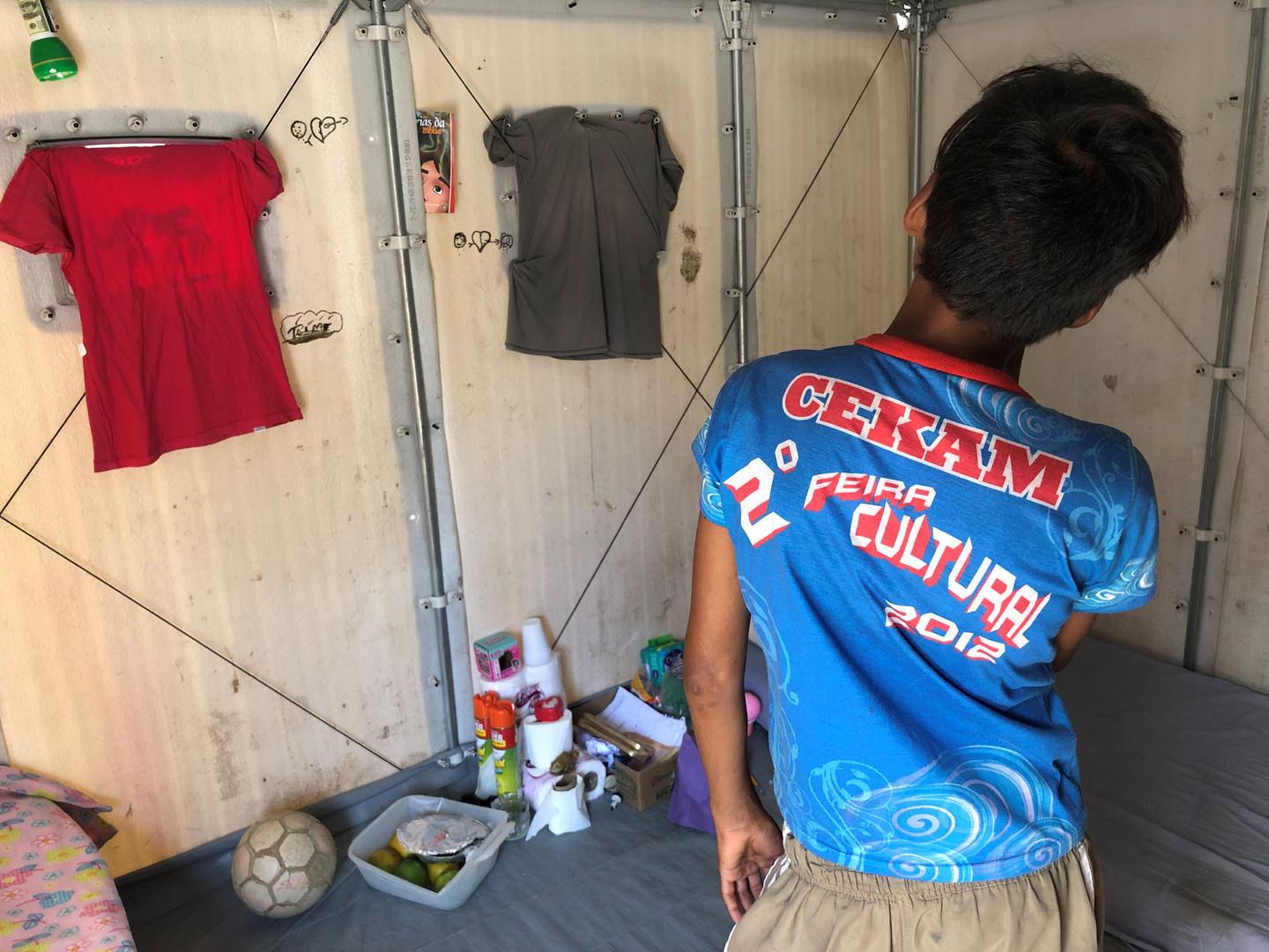 Pedro M., 12, inside the housing unit where he lives with his sister Mariana, 13, at a UN shelter in Roraima in October 2019. Photo by César Muñoz 