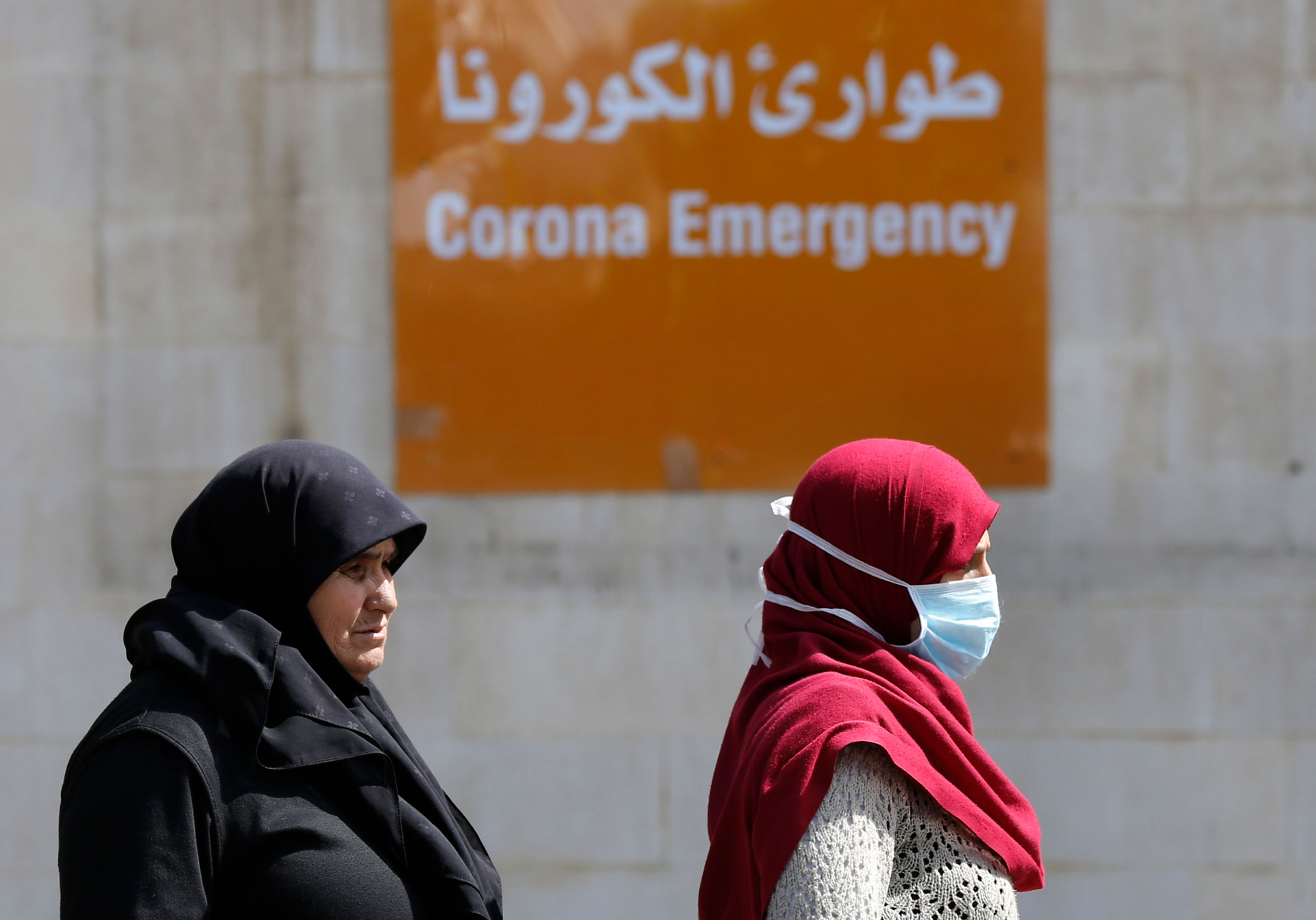 People pass in front the emergency entrance of the government-run Rafik Hariri University Hospital, where most of the Lebanese coronavirus cases are treated, in Beirut, Lebanon, March 11, 2020.
