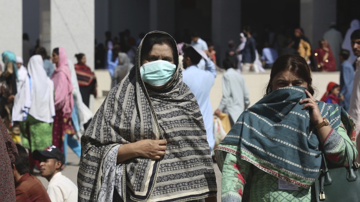 Pakistani women wearing face masks leave the Aga Khan hospital where a patient suspected of having contracted coronavirus was admitted, in Karachi, Pakistan, Thursday, Feb. 27, 2020. 
