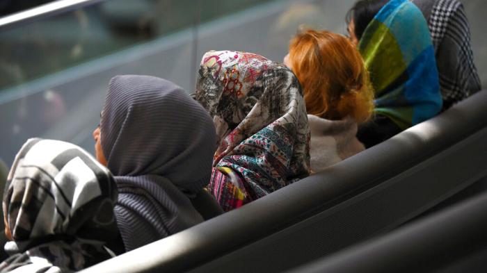 Young women with headscarves sit in the Bundestag in Berlin, Germany on January 31, 2020. 