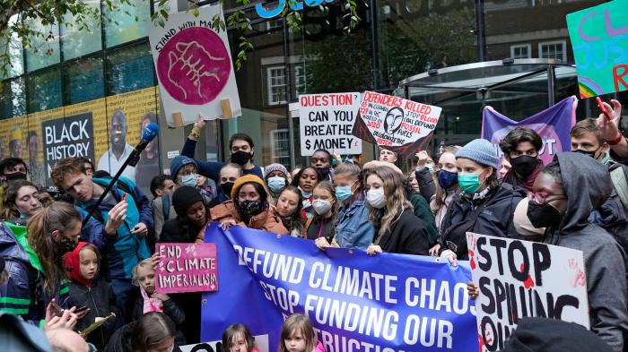 Climate activist Greta Thunberg, center, demonstrates with others in front of the Standard and Chartered Bank during a climate protest in London, England, October 29, 2021