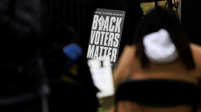 People attend a rally held by the Southern Poverty Law Center near the U.S. Capitol on October 4, 2022