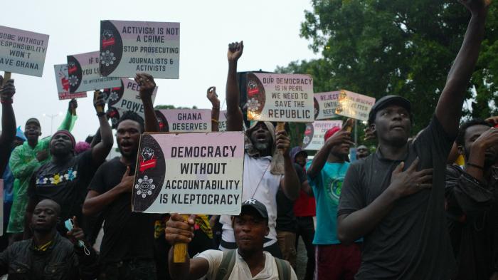 Protesters hold placards during a demonstration in Accra, Ghana against deteriorating economic conditions and fund mismanagement  in the country, on September 22, 2023. (c) 2023  NIPAH DENNIS/AFP via Getty Images