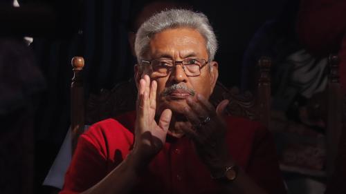 A older man in glasses clapping