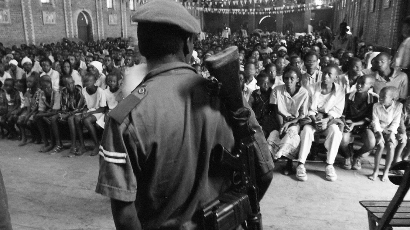 A crowd of mostly Tutsi civilians, seeking protection against Hutu militiamen, sit in the Sainte Famille Catholic church in the then-government controlled part of Kigali, listening to a member of the security services address them. Over several months, ma