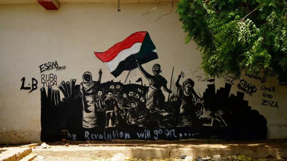لوحة جدارية كتب عليها بالإنغليزية "الثورة ستستمر" على حائط في الخرطوم، 18 يونيو/حزيران 2019. 