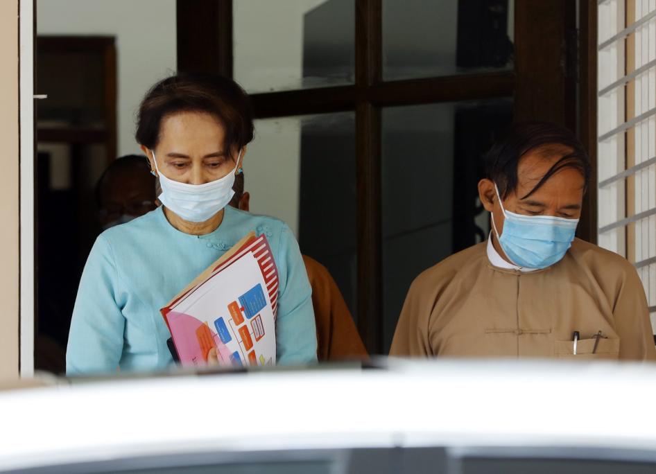 Myanmar leader Aung San Suu Kyi, left, and President Win Myint, wearing face masks to protect against the new coronavirus, leave after a Central Executive Committee meeting at their National League for Democracy (NLD) party headquarters in Naypyitaw, Myanmar Tuesday, July 21, 2020. 