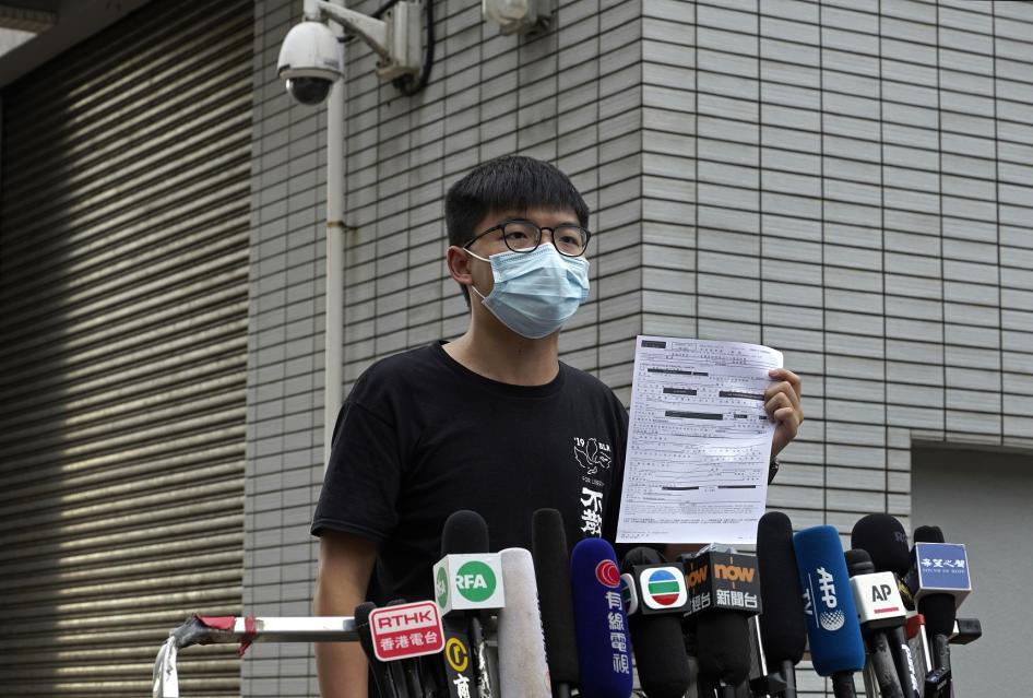 Hong Kong pro-democracy activist Joshua Wong displays a bail paper outside Central Police Station in Hong Kong, Thursday, Sept. 24, 2020. 